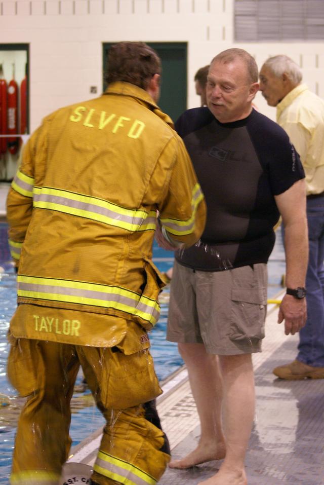 A wet 1st Assistant Chief Casey Taylor is congratulated by Dive Captain Ken Mclaughlin after surviving his fall!!! Lifeguard Systems &quot;Drown Proofing Firefighter Turn Out Gear&quot; 1/6/2012